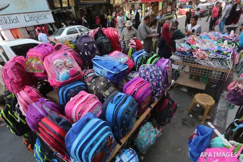 Palestinians shop during preparation for the new school year at a market in Gaza city, on August 27, 2016. Photo by Mohammed Asad