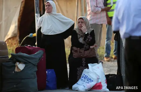 Palestinians Muslim pilgrims wait at Al-Karama crossing between the West Bank and Jordan near Jericho, on August 28, 2016, before leaving for the annual hajj pilgrimage to the holy city of Mecca. Hundreds of Palestinian...