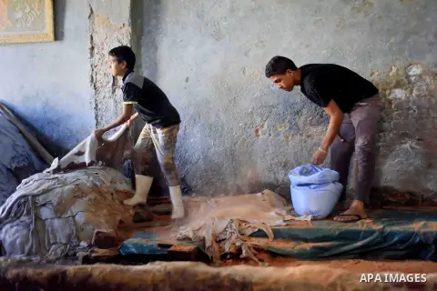 Egyptian leather tannery workers, salt the hides of animals before drying them, at a leather tannery, in Cairo, Egypt, on August 28, 2016. Photo by Amr Sayed