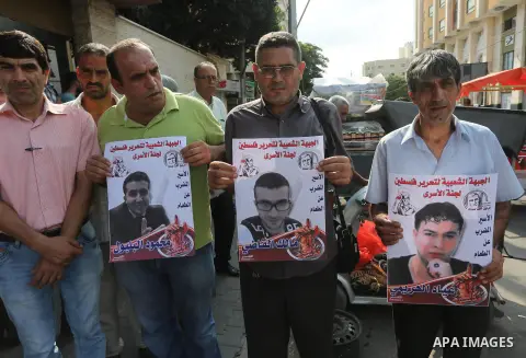 Palestinians take part in a protest demanding release the prisoners in Israeli jails, in front of Red cross office in Gaza city, on August 29, 2016. Photo by Mohammed Asad