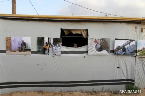 Palestinians attend the photographic exhibition "houses without columns", in Khuza'a, in the east of the town of Khan Younis in southern Gaza Strip, on August 30, 2016. Photo by Abed Rahim Khatib