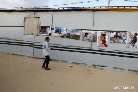 Palestinians attend the photographic exhibition "houses without columns", in Khuza'a, in the east of the town of Khan Younis in southern Gaza Strip, on August 30, 2016. Photo by Abed Rahim Khatib