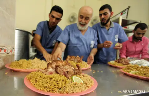 Chairman of Turkish humanitarian relief (IHH), Mohammed Kaya, attends the opening ceremony of a kitchen martyrs of the Freedom Flotilla (Mavi Marmara), which provides free meals for poor families, in Gaza city, on Sept....