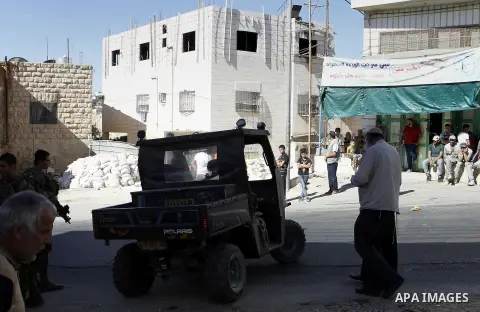 Israeli security forces stand guard after a Palestinian prevent the building of his house, near Kiryat Arba on the outskirts of the West Bank city of Hebron, on Sept. 02, 2016. Photo by Wisam Hashlamoun