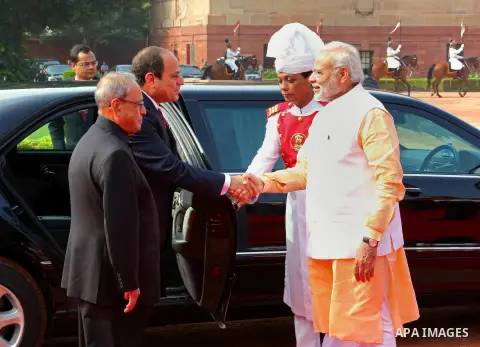 Egypt's President Abdel Fattah al-Sisi shakes hands with India's Prime Minister Narendra Modi as his Indian counterpart Pranab Mukherjee watches during the ceremonial reception at presidential palace in New Delhi on Sept...