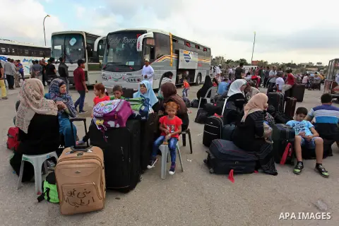 Palestinians wait for travel permits to cross into Egypt through the Rafah border crossing after it was opened by Egyptian authorities, in the southern Gaza Strip September 3, 2016. Photo by Ashraf Amra