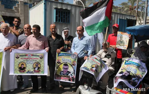 Palestinians hold banners during a protest to show solidarity with Palestinian prisoners on hunger strike in Israeli Jails, in front of the high commissioner for human rights headquarters in Gaza City, on Sept. 04, 2016....