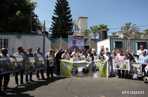 Palestinians hold banners during a protest to show solidarity with Palestinian prisoners on hunger strike in Israeli Jails, in front of the high commissioner for human rights headquarters in Gaza City, on Sept. 04, 2016....