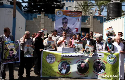 Palestinians hold banners during a protest to show solidarity with Palestinian prisoners on hunger strike in Israeli Jails, in front of the high commissioner for human rights headquarters in Gaza City, on Sept. 04, 2016....