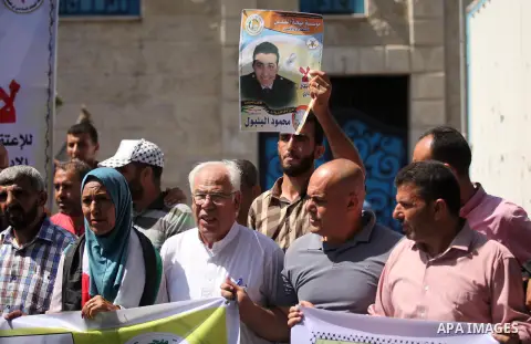 Palestinians hold banners during a protest to show solidarity with Palestinian prisoners on hunger strike in Israeli Jails, in front of the high commissioner for human rights headquarters in Gaza City, on Sept. 04, 2016....