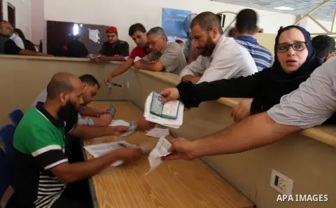 Palestinians wait for travel permits to cross into Egypt through the Rafah border crossing, on September 4, 2016 in the southern Gaza Strip. Egyptian authorities temporarily reopened it both directions for two days in Ga...