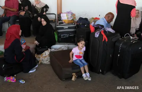 Palestinians wait for travel permits to cross into Egypt through the Rafah border crossing, on September 4, 2016 in the southern Gaza Strip. Egyptian authorities temporarily reopened it both directions for two days in Ga...