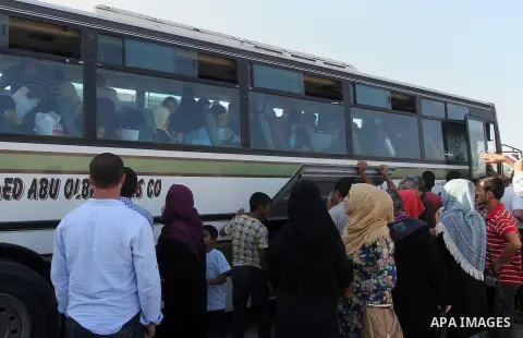 Palestinians wait for travel permits to cross into Egypt through the Rafah border crossing, on September 4, 2016 in the southern Gaza Strip. Egyptian authorities temporarily reopened it both directions for two days in Ga...