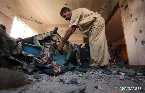 A Palestinian man inspects his house after it was hit by Israeli tank fire on September 6, 2016 in Beit Hanun in the northern Gaza Strip. Israel's army targeted Hamas posts in the Gaza Strip with tank fire after gunfire...