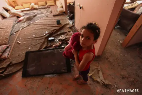 A Palestinian girl carries her doll inside her family house after it was hit by Israeli tank fire on September 6, 2016 in Beit Hanun in the northern Gaza Strip. Israel's army targeted Hamas posts in the Gaza Strip with t...