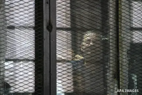 Egyptian Muslim Brotherhood defendants are seen behind bars during their trial, in a case known in media as "Rabaa Operations Room", in Cairo, on Sep. 06, 2016. Photo by Amr Sayed