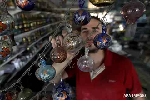 A Palestinian man uses types of glasses to decorate his factory in the West Bank city of Hebron, on Sep. 07, 2016. Hebron, the largest city in the West Bank has been officially awarded the title of World Crafts City, Rol...