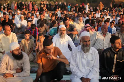 Palestinians attend the morning prayer of the Muslim holiday of the Eid al-Adha on September 12, 2016, in Khan Younis in the southern Gaza strip. Muslims across the world celebrate the annual festival of Eid al-Adha, or...