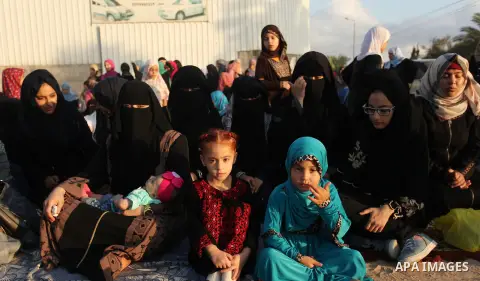 Palestinians attend the morning prayer of the Muslim holiday of the Eid al-Adha on September 12, 2016, in Khan Younis in the southern Gaza strip. Muslims across the world celebrate the annual festival of Eid al-Adha, or...
