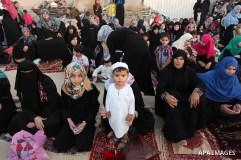 Palestinians attend the morning prayer of the Muslim holiday of the Eid al-Adha on September 12, 2016, in Khan Younis in the southern Gaza strip. Muslims across the world celebrate the annual festival of Eid al-Adha, or...