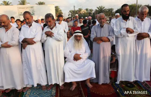 Palestinians attend the morning prayer of the Muslim holiday of the Eid al-Adha on September 12, 2016, in Khan Younis in the southern Gaza strip. Muslims across the world celebrate the annual festival of Eid al-Adha, or...