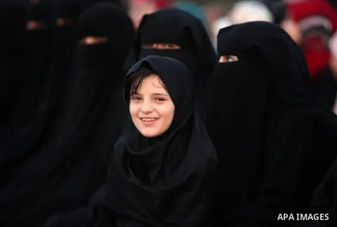A Palestinian girl attends the morning prayer of the Muslim holiday of the Eid al-Adha on September 12, 2016, in Khan Younis in the southern Gaza strip. Muslims across the world celebrate the annual festival of Eid al-Ad...