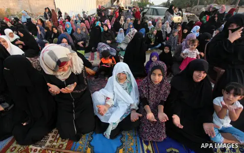 Palestinians attend the morning prayer of the Muslim holiday of the Eid al-Adha on September 12, 2016, in Khan Younis in the southern Gaza strip. Muslims across the world celebrate the annual festival of Eid al-Adha, or...