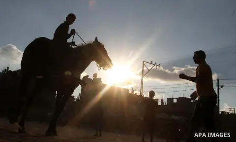 Palestinian children ride a horse on the second day of Eid al-Adha or the feast of sacrifice, in Rafah in the southern of Gaza strip, on Sep. 13, 2016. Muslims across the world are celebrating the annual festival of Eid...