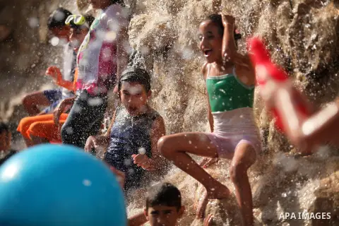 Palestinian children play at an amusement park on the third day of Eid al-Adha or the feast of sacrifice in Gaza city, on Sep. 14, 2016. Muslims across the world are celebrating the annual festival of Eid al-Adha, or the...
