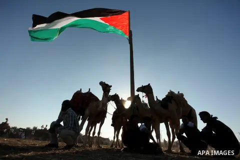 Palestinians ride camels during a Bedouin festival in Dair Al Balah in the central Gaza Strip September 16, 2016. Photo by Ashraf Amra