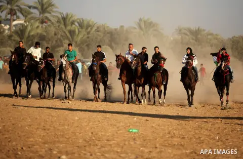 Palestinians ride horses during a Bedouin festival in Dair Al Balah in the central Gaza Strip September 16, 2016. Photo by Ashraf Amra