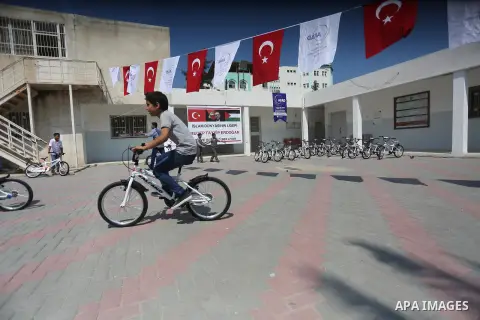 Palestinian orphan student receive bicycles from Turkish aid "clips", in Gaza City, on Sept. 17, 2016. Photo by Mohammed Asad