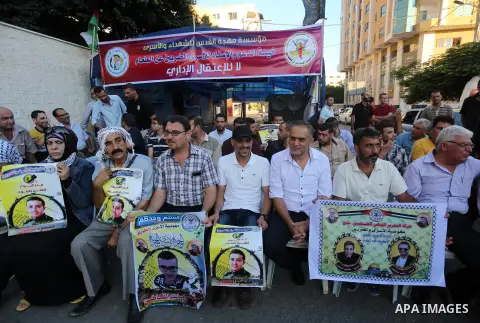 Palestinian supporters of Fatah movement take part during a protest to show solidarity with Palestinian prisoners on hunger strike in Israeli Jails, in front of Red cross office in Gaza city, on Sept. 18, 2016. Photo by...