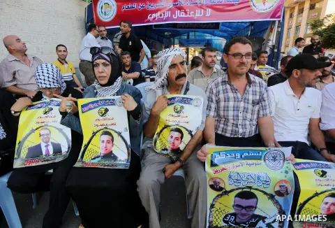 Palestinian supporters of Fatah movement take part during a protest to show solidarity with Palestinian prisoners on hunger strike in Israeli Jails, in front of Red cross office in Gaza city, on Sept. 18, 2016. Photo by...