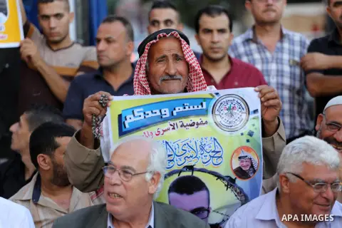Palestinian supporters of Fatah movement take part during a protest to show solidarity with Palestinian prisoners on hunger strike in Israeli Jails, in front of Red cross office in Gaza city, on Sept. 18, 2016. Photo by...