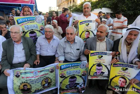 Palestinian supporters of Fatah movement take part during a protest to show solidarity with Palestinian prisoners on hunger strike in Israeli Jails, in front of Red cross office in Gaza city, on Sept. 18, 2016. Photo by...