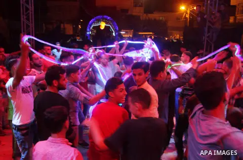 Palestinians celebrate during a traditional wedding party in Arabic "Henna's Night" in Rafah in the southern Gaza strip on Sep. 20, 2016. Palestinians perform the traditional dancing style derived from their folklore, th...