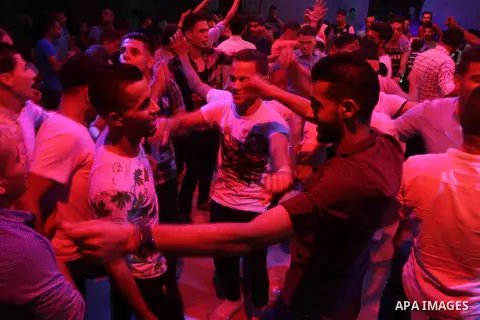 Palestinians celebrate during a traditional wedding party in Arabic "Henna's Night" in Rafah in the southern Gaza strip on Sep. 20, 2016. Palestinians perform the traditional dancing style derived from their folklore, th...