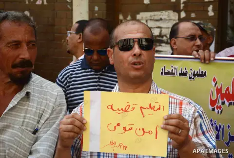 Egyptian teachers hold placards during a demonstration against the education system and demanding the resignation of Education Minister Al-Helali el-Sherbini outside Journalists' Syndicate in Cairo, Egypt, on Sep. 20, 20...