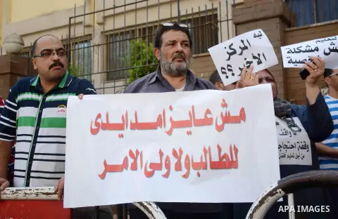 Egyptian teachers hold placards during a demonstration against the education system and demanding the resignation of Education Minister Al-Helali el-Sherbini outside Journalists' Syndicate in Cairo, Egypt, on Sep. 20, 20...