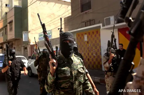 Palestinian militants of the Nasser Salah al-Din Brigades the military wing of the Popular Resistance movement take part in a press conference, in Gaza City on Sept. 27, 2016. Photo by Ashraf Amra