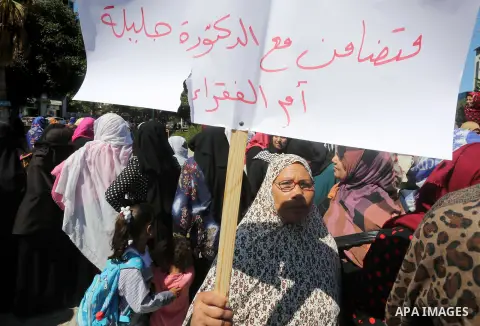 Palestinians hold banners during a protest due to prevent Ms. Jalila Dahlan from entering the Gaza Strip, in Gaza city, on Sept. 28, 2016. Photo by Mohammed Asad