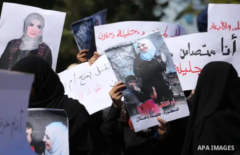 Palestinians hold banners during a protest due to prevent Ms. Jalila Dahlan from entering the Gaza Strip, in Gaza city, on Sept. 28, 2016. Photo by Mohammed Asad