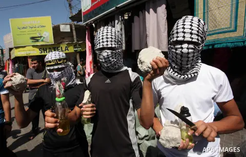 Palestinian supporters of the Islamic Jihad Movement take part in a demonstration marking the first anniversary of the so-called Al-Quds uprising in Gaza city, on October 2, 2016. Photo by Ashraf Amra