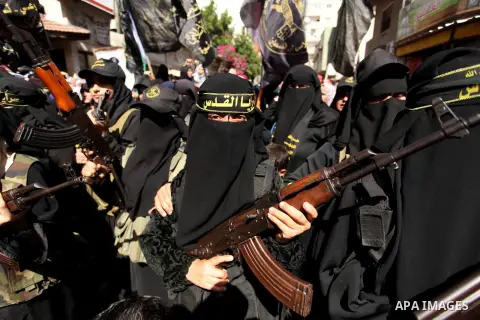 Palestinian women from the Islamic Jihad Movement flash their weapons during a demonstration marking the first anniversary of the so-called Al-Quds uprising in Gaza city, on October 2, 2016. Photo by Ashraf Amra