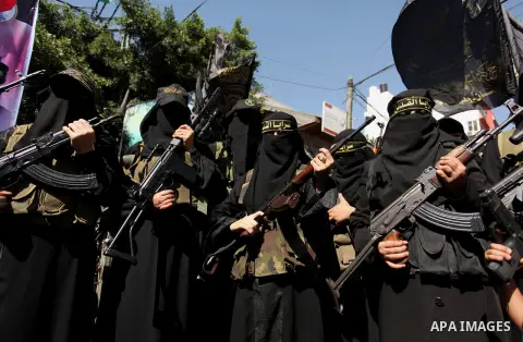 Palestinian women from the Islamic Jihad Movement flash their weapons during a demonstration marking the first anniversary of the so-called Al-Quds uprising in Gaza city, on October 2, 2016. Photo by Ashraf Amra
