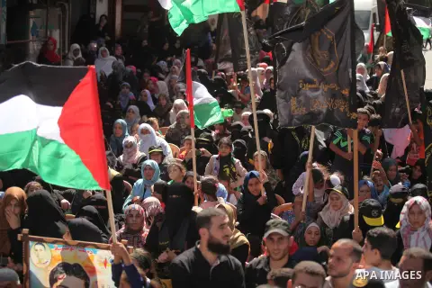 Palestinian supporters of the Islamic Jihad Movement take part in a demonstration marking the first anniversary of the so-called Al-Quds uprising in Gaza city, on October 2, 2016. Photo by Ashraf Amra