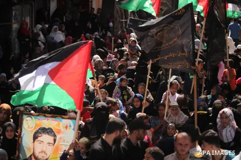 Palestinian supporters of the Islamic Jihad Movement take part in a demonstration marking the first anniversary of the so-called Al-Quds uprising in Gaza city, on October 2, 2016. Photo by Ashraf Amra