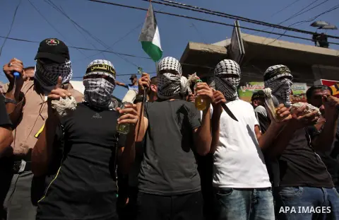 Palestinian supporters of the Islamic Jihad Movement take part in a demonstration marking the first anniversary of the so-called Al-Quds uprising in Gaza city, on October 2, 2016. Photo by Ashraf Amra