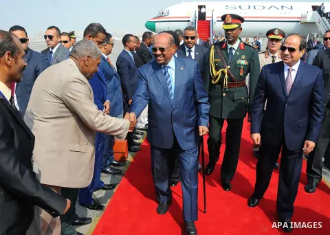 Egyptian President Abdel Fattah al-Sisi walks alongside with Sudanese President Omar al-Bashir upon his arrival at Cairo's international airport in Cairo, Egypt, on Oct. 05, 2016. Photo by Egyptian President Office